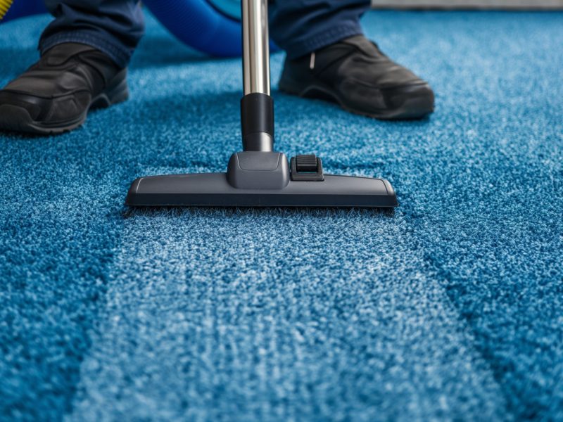 Person Cleaning Carpet With Vacuum Cleaner, Cleaning In Living Room.